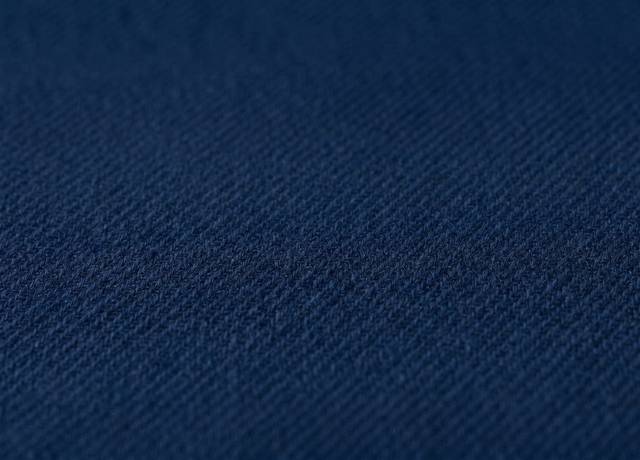 Dark blue fabric with a blending navy button and a contrasting white button
